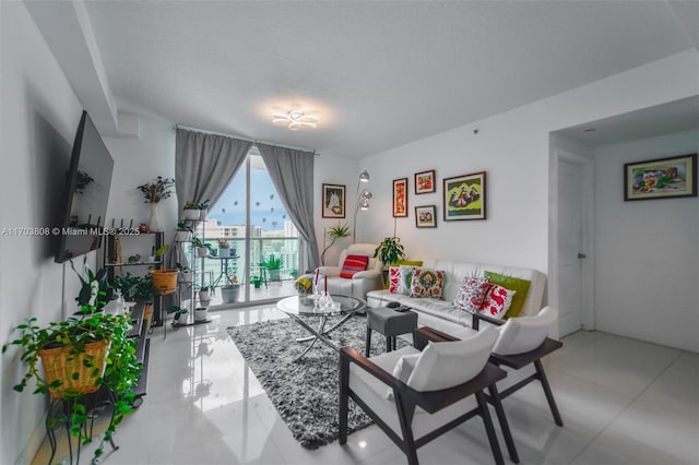 living room with a wall of windows and a textured ceiling