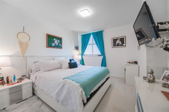 tiled bedroom with a textured ceiling