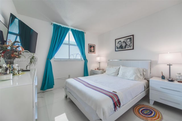 bedroom with light tile patterned floors