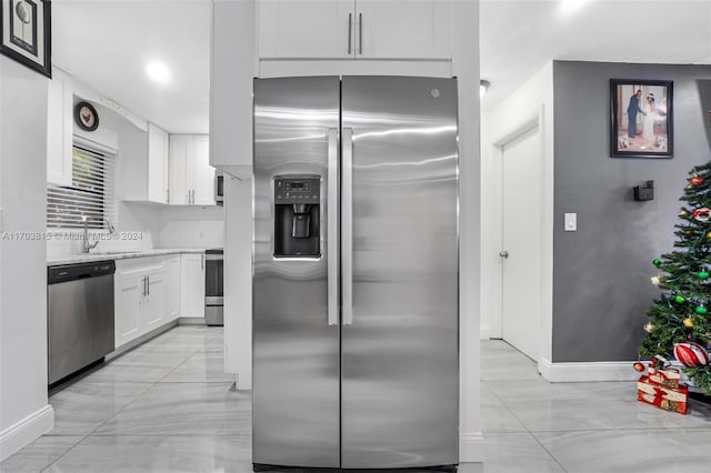 kitchen featuring white cabinets, sink, and stainless steel appliances