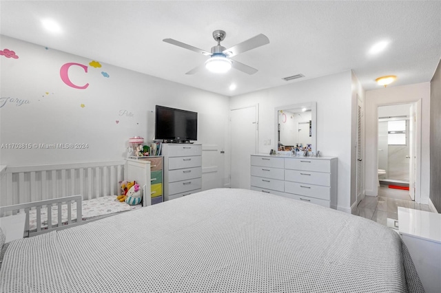 bedroom with ensuite bath and ceiling fan