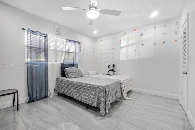 bedroom featuring ceiling fan and a closet