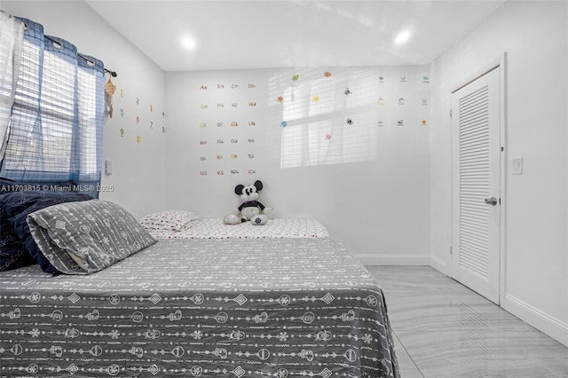 bedroom featuring a closet and baseboards