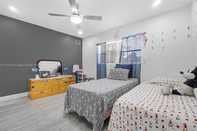 bedroom with a ceiling fan, visible vents, and baseboards