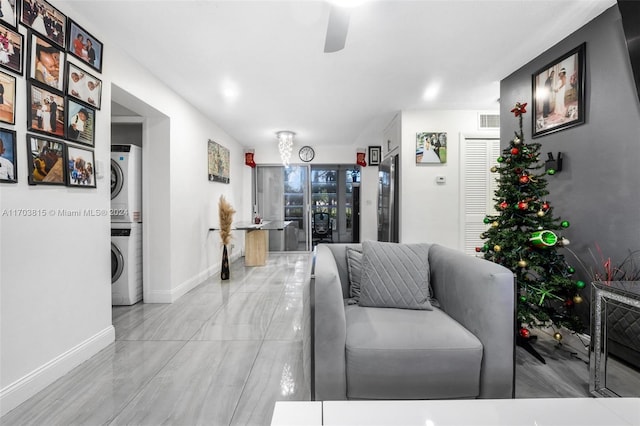 living room with stacked washing maching and dryer