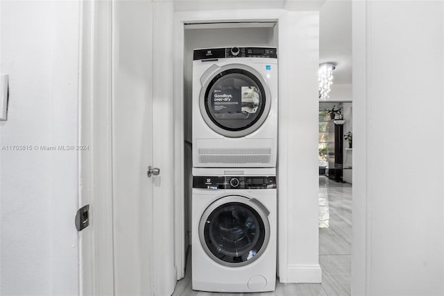 laundry room with stacked washer / drying machine