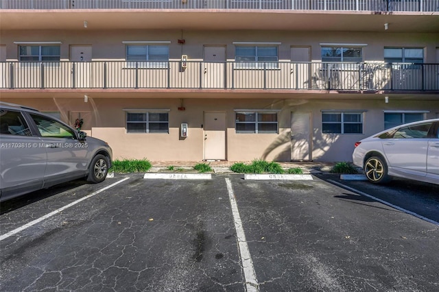 view of property featuring uncovered parking