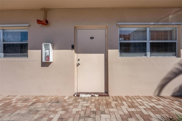 entrance to property with stucco siding