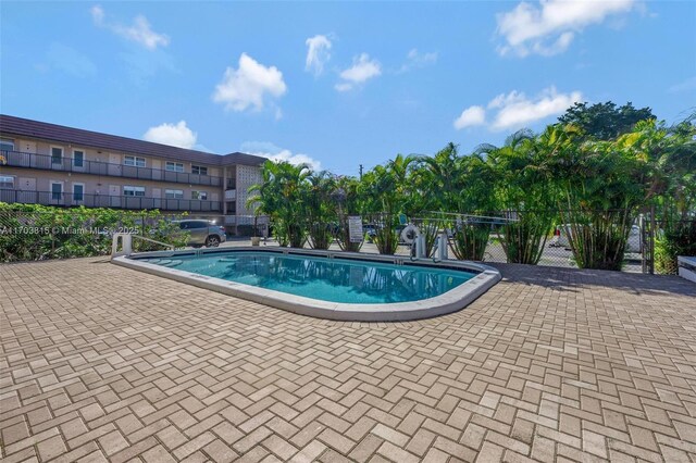 pool featuring a patio area and fence