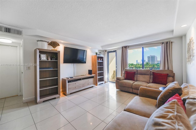 tiled living room featuring a textured ceiling