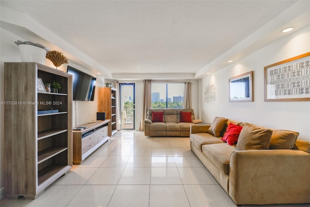 living room with light tile patterned floors and a textured ceiling