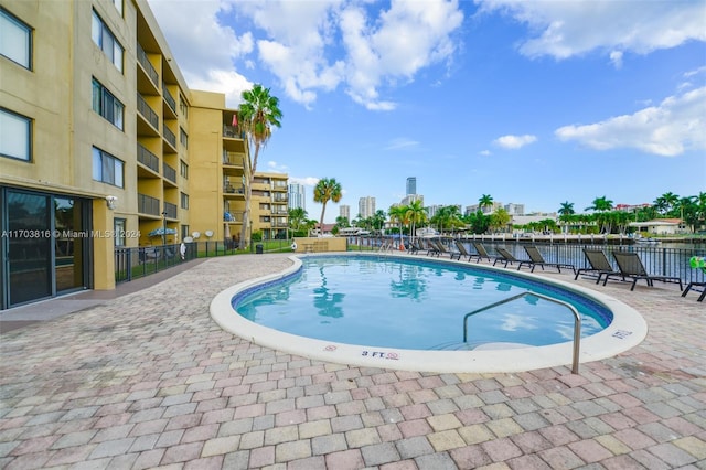 view of swimming pool with a water view