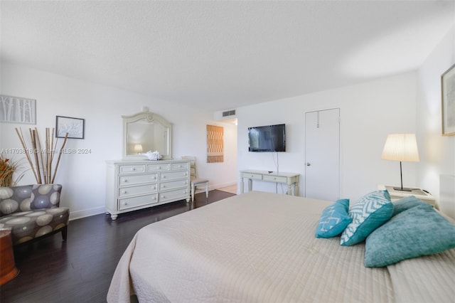 bedroom featuring dark hardwood / wood-style flooring