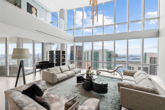 living room featuring a water view and a high ceiling