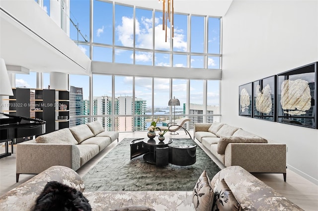 living room with a high ceiling and light hardwood / wood-style floors