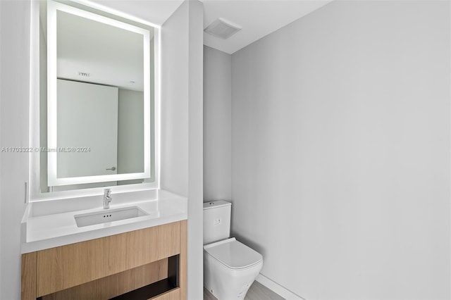 bathroom with vanity and toilet