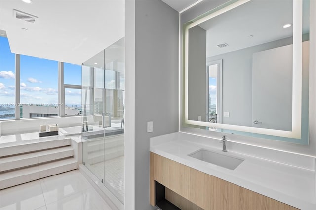 bathroom featuring a shower with shower door, tile patterned floors, and vanity