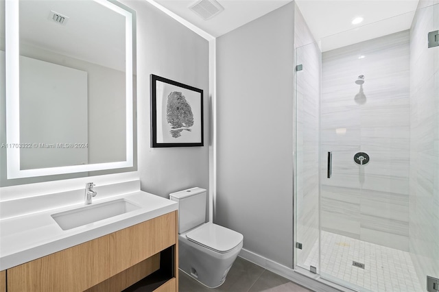 bathroom with vanity, toilet, walk in shower, and tile patterned floors