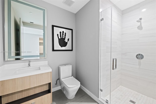 bathroom with tile patterned floors, toilet, a shower with door, and vanity