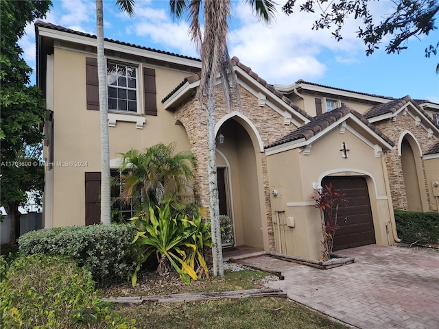 mediterranean / spanish-style house with a garage