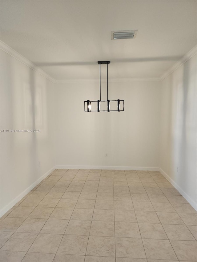 tiled empty room featuring ornamental molding