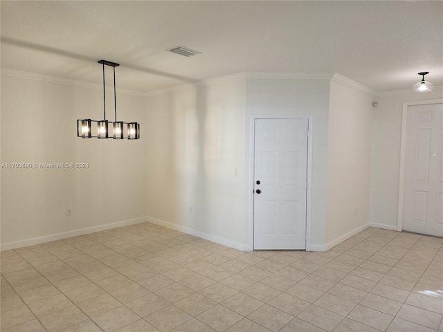 spare room featuring light tile patterned flooring and crown molding