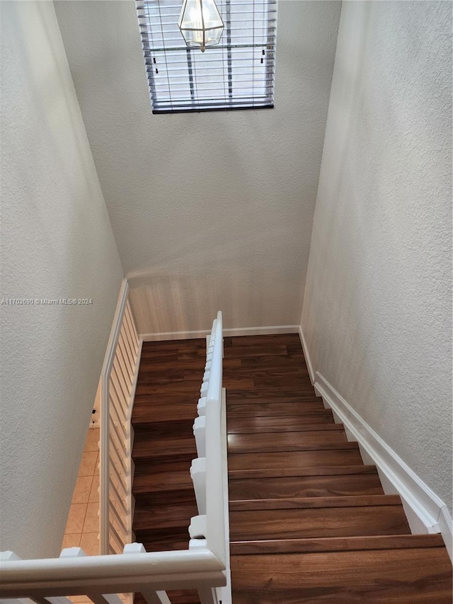 stairway featuring wood-type flooring