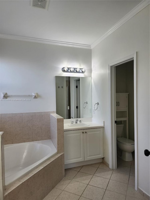 bathroom featuring tile patterned floors, ornamental molding, vanity, tiled tub, and toilet