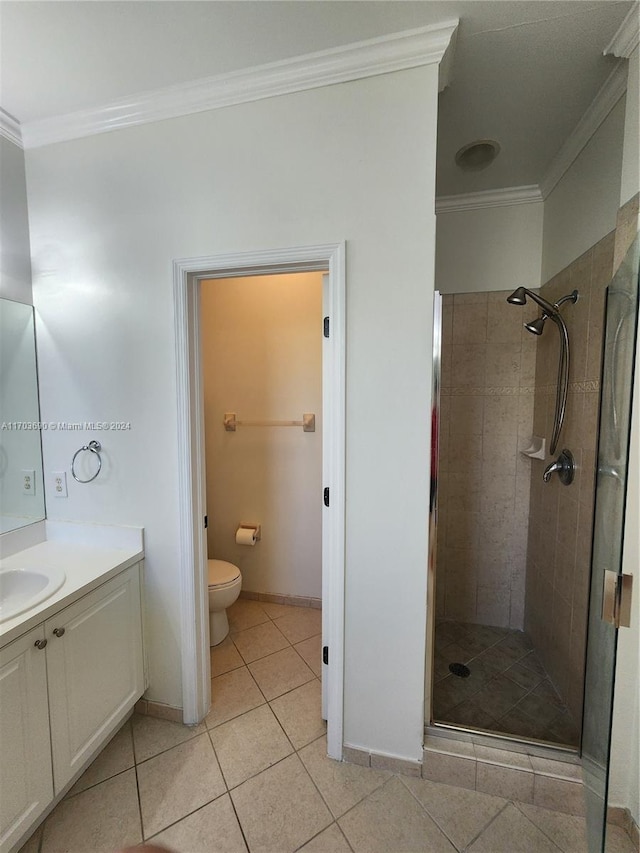 bathroom with tile patterned floors, walk in shower, vanity, crown molding, and toilet