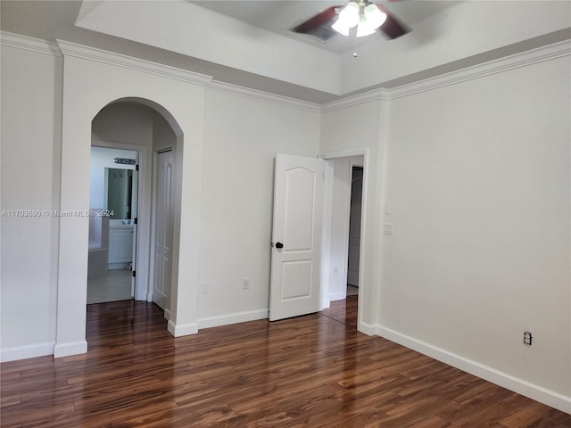 spare room with dark hardwood / wood-style flooring, ceiling fan, and ornamental molding