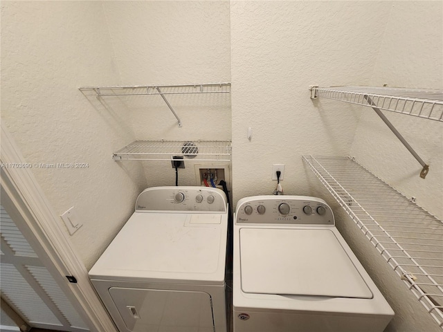 clothes washing area featuring separate washer and dryer