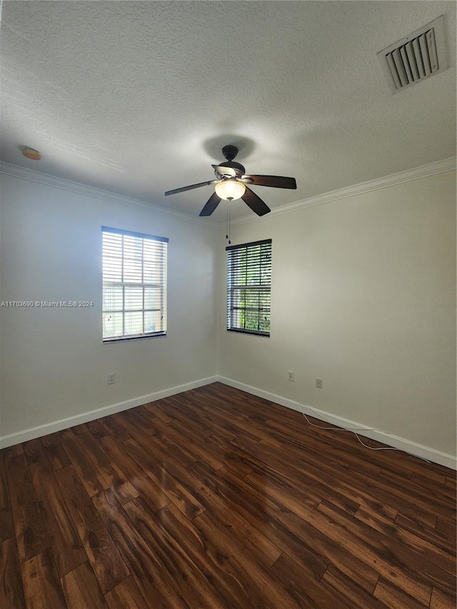 spare room with ceiling fan, dark hardwood / wood-style flooring, a textured ceiling, and ornamental molding