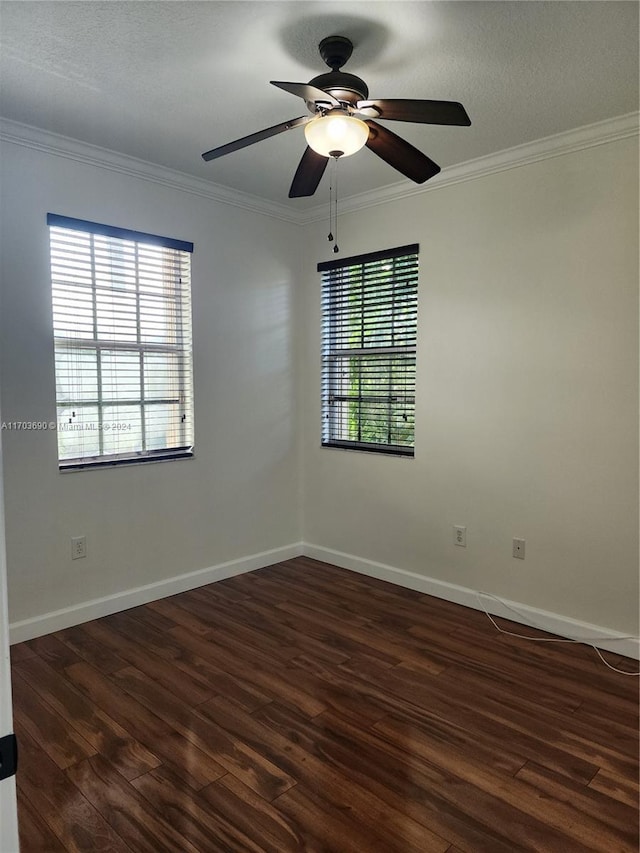 spare room featuring ceiling fan, dark hardwood / wood-style flooring, a healthy amount of sunlight, and ornamental molding