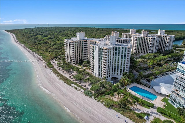 drone / aerial view featuring a beach view and a water view