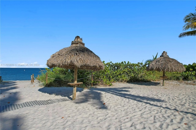 surrounding community with a gazebo and a water view