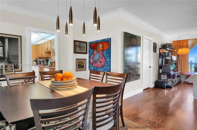 dining room with dark hardwood / wood-style flooring, a textured ceiling, and ornamental molding