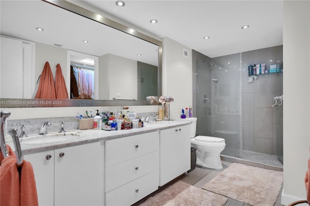 bathroom with tile patterned flooring, vanity, toilet, and walk in shower