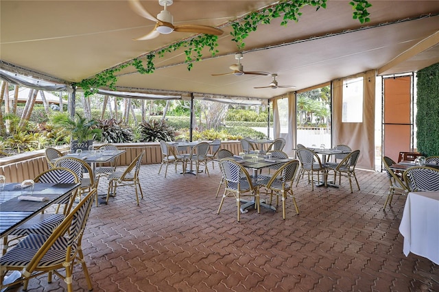 sunroom / solarium featuring ceiling fan and lofted ceiling