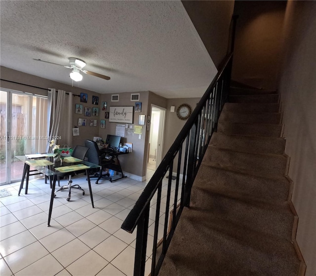 interior space with tile patterned floors, ceiling fan, and a textured ceiling