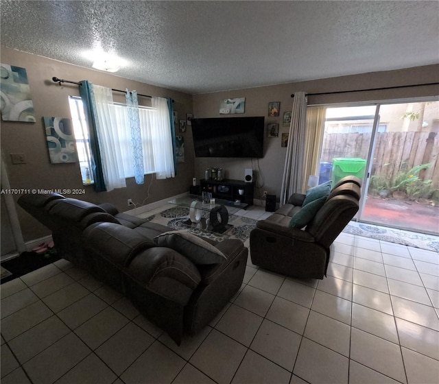 living room featuring light tile patterned floors and a textured ceiling