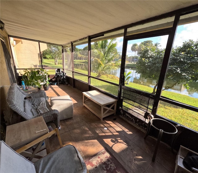 sunroom / solarium with a water view and wooden ceiling