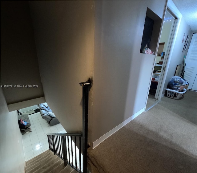 stairway with tile patterned flooring