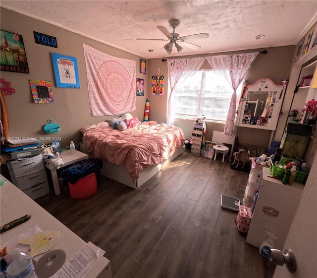 bedroom with a textured ceiling, dark hardwood / wood-style floors, and ceiling fan