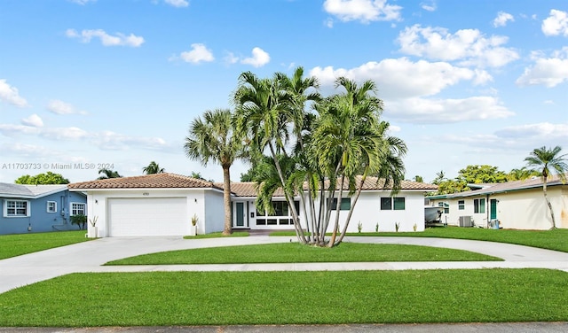 view of front facade with a front lawn, central AC unit, and a garage