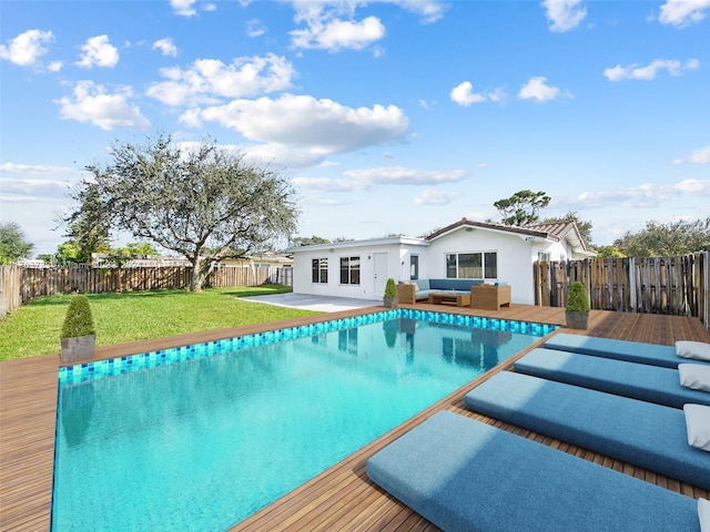 view of swimming pool featuring a lawn, an outdoor hangout area, and a deck