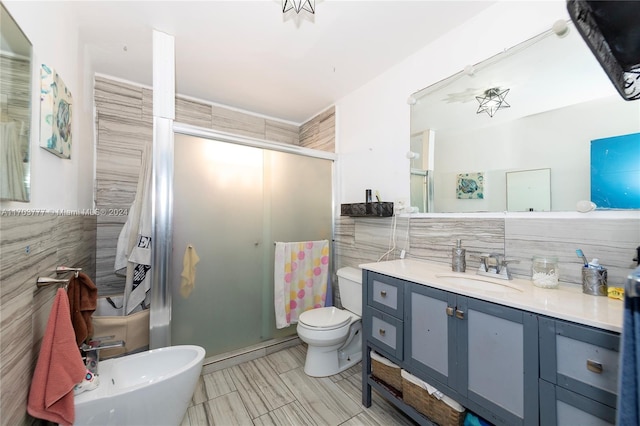 bathroom featuring vanity, a bidet, toilet, tile walls, and an enclosed shower