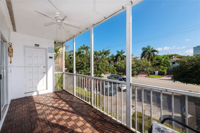 unfurnished sunroom featuring ceiling fan