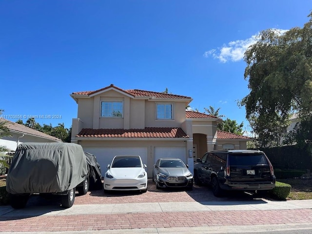 mediterranean / spanish house with a garage