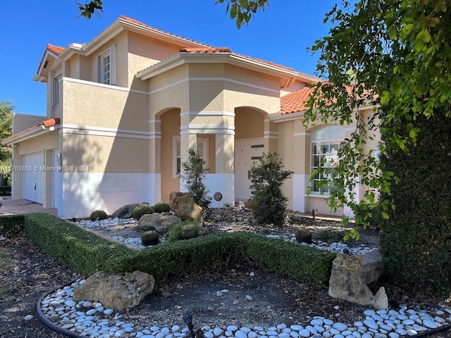 mediterranean / spanish-style house featuring a garage