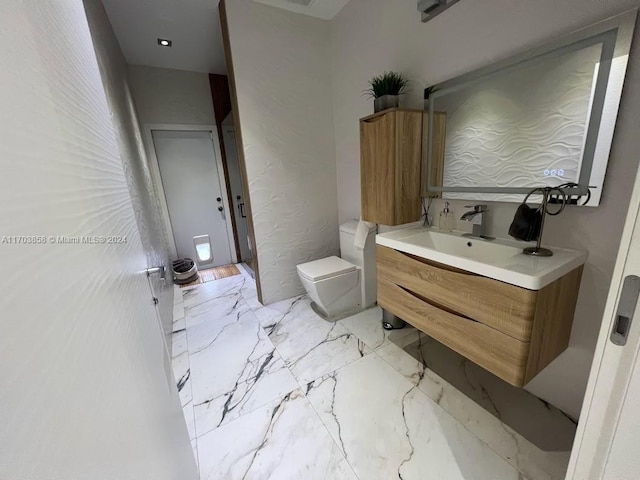 bathroom with vanity and toilet